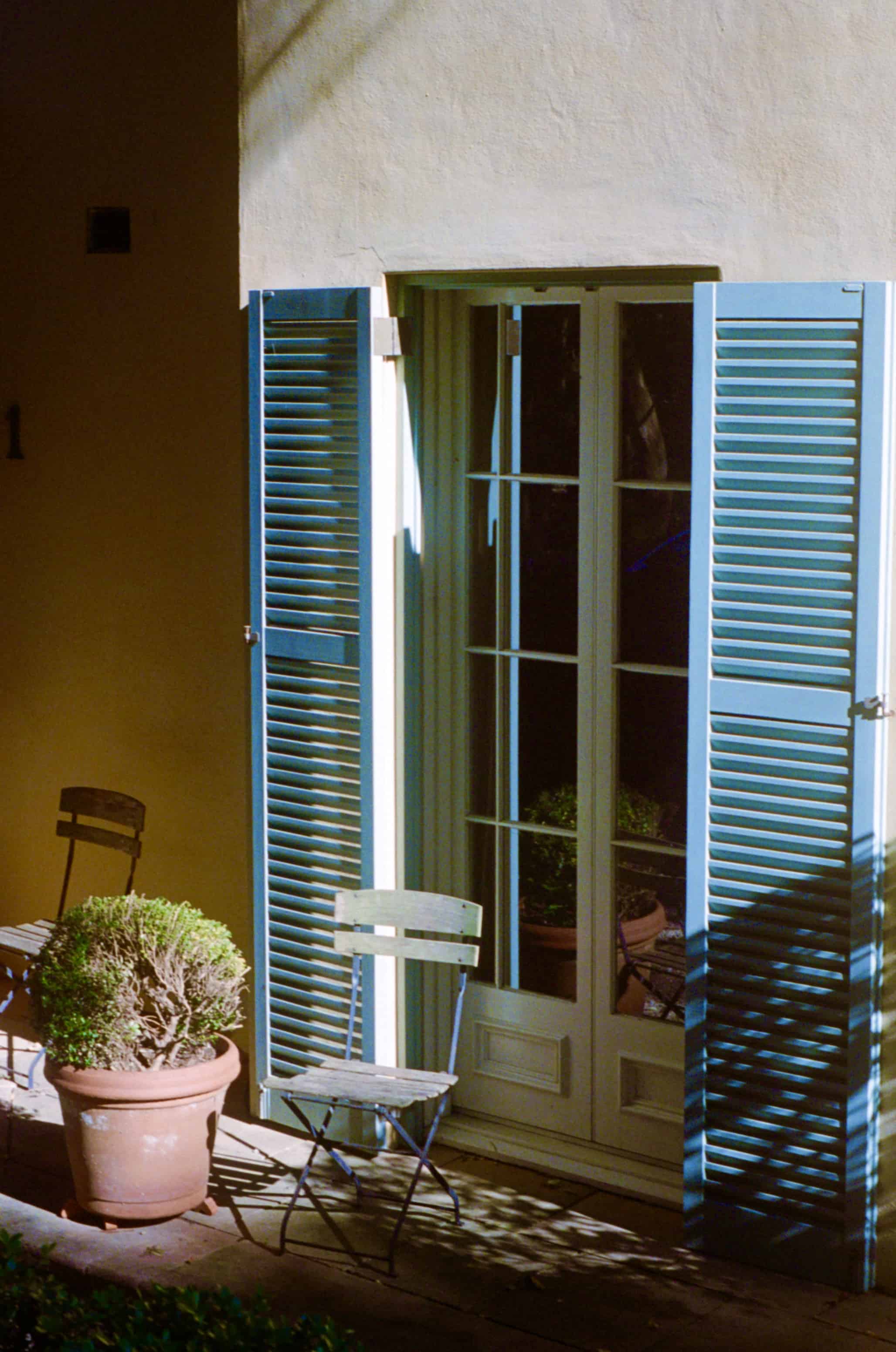 a chair in front of a blue window