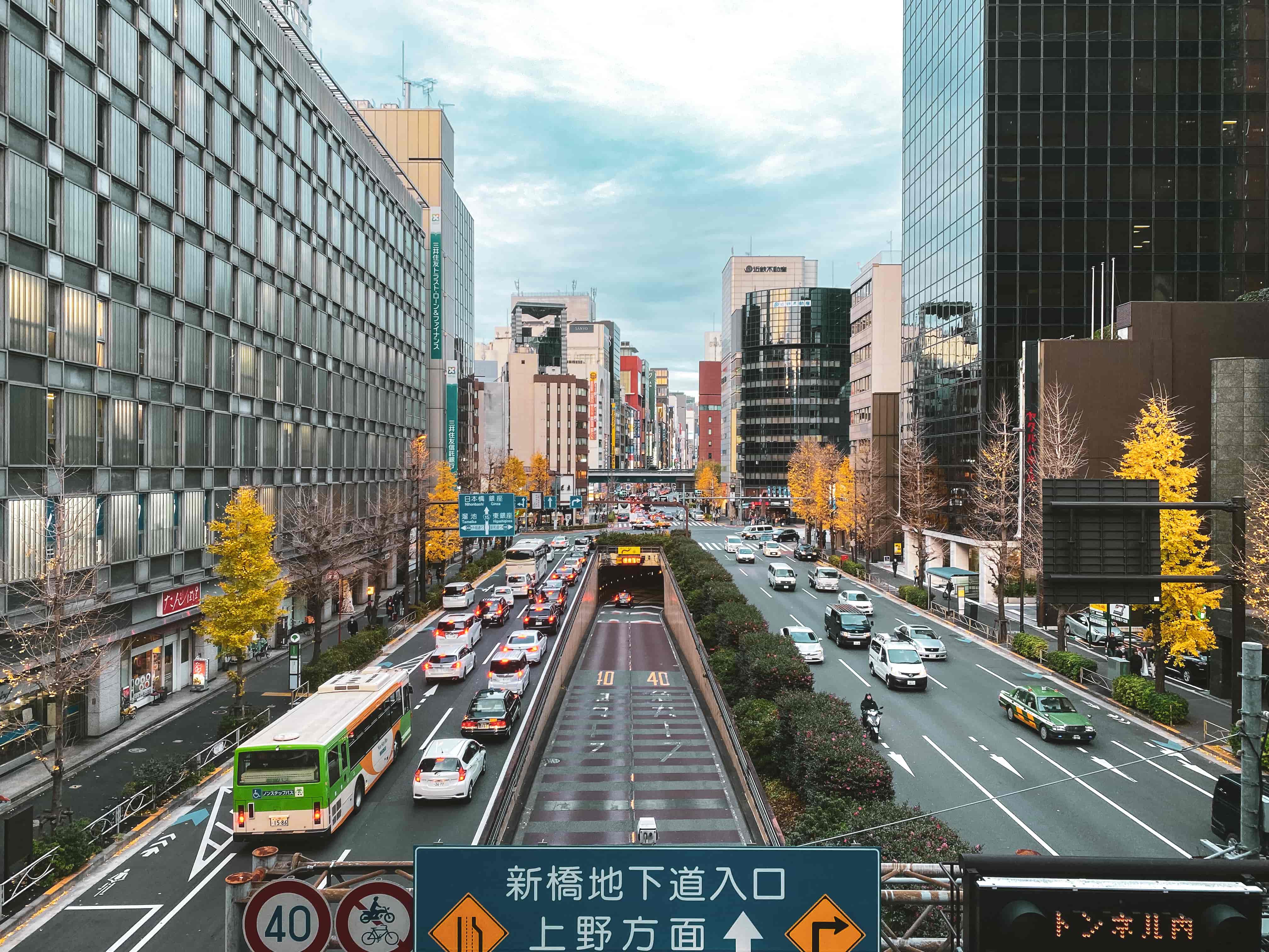 A view of cars on road with buildings surrounding